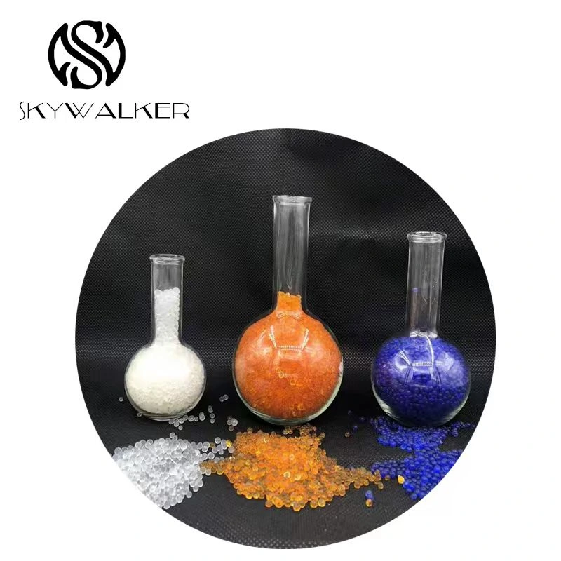White, orange and blue silica gel materials in laboratory flasks